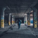 man walking hallway during daytime