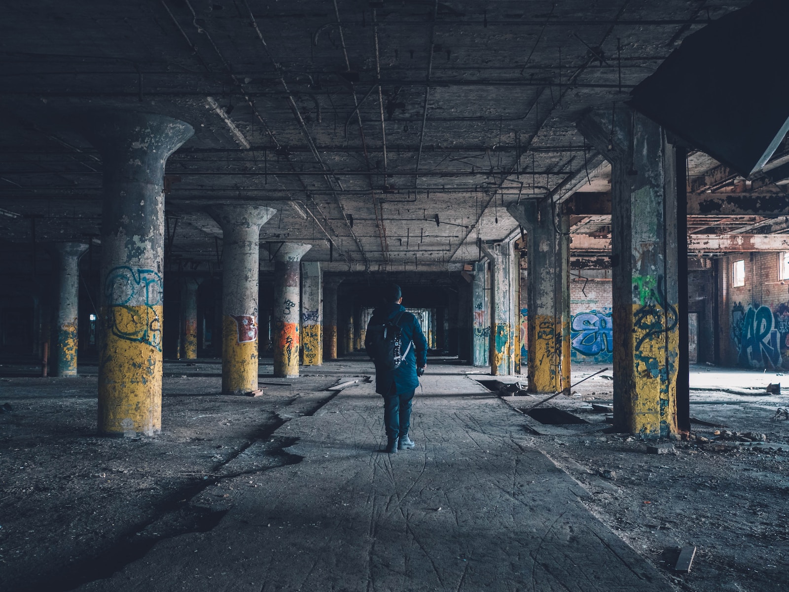 man walking hallway during daytime